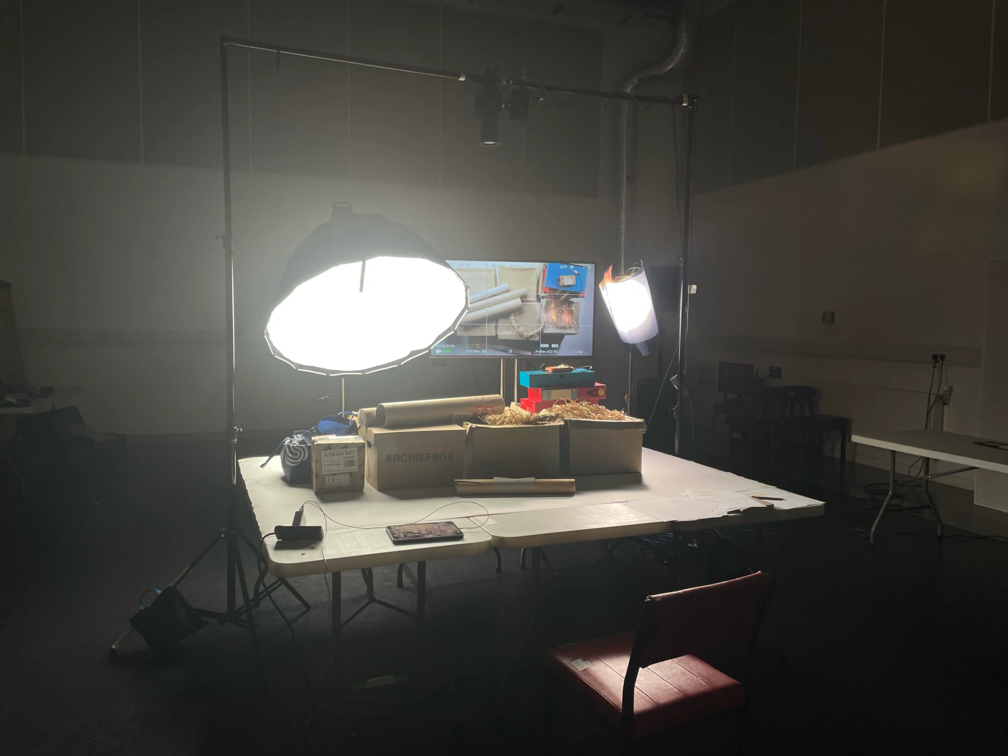 Behind the scenes at National Theatre of Scotland: archive boxes on a photography table lit by softbox lights