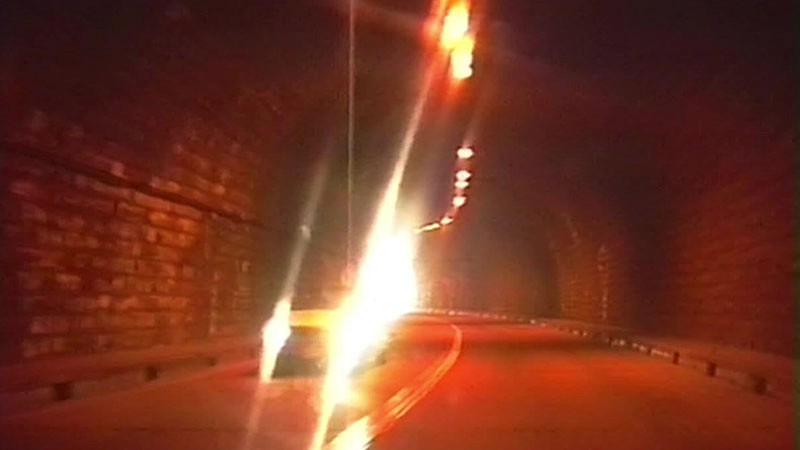 Hi8 footage still: driving through a dark brick tunnel, lights streaking across the frame