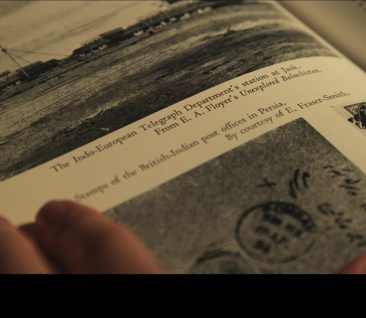 Close-up film still of a book page showing the Indo-European Telegraph Department's station at Jask