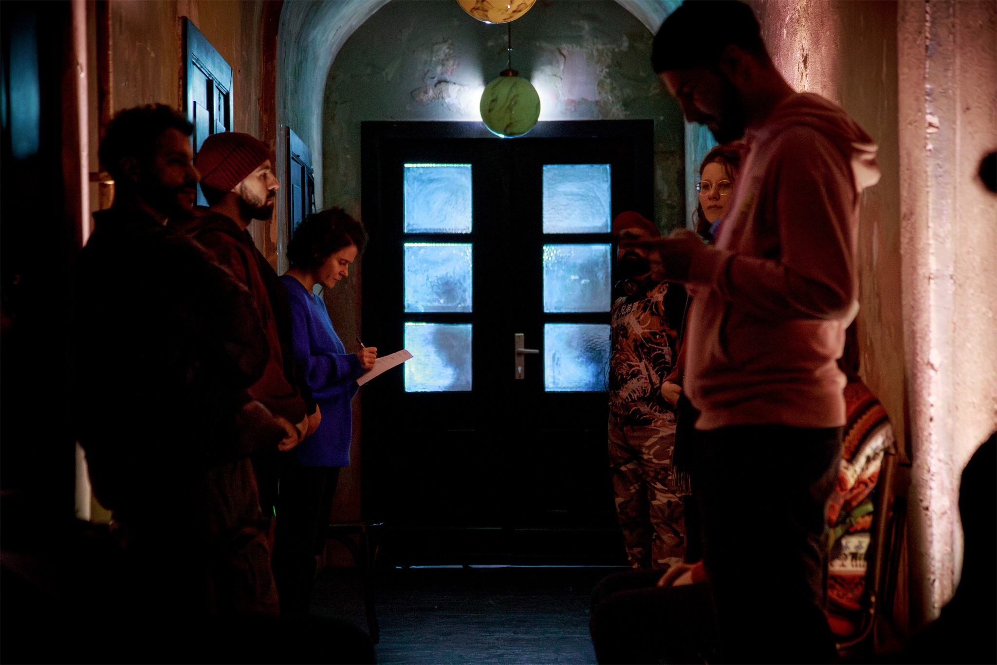Ksenia Ravvina marks cuts to the script in a dim corridor during the dress rehearsal