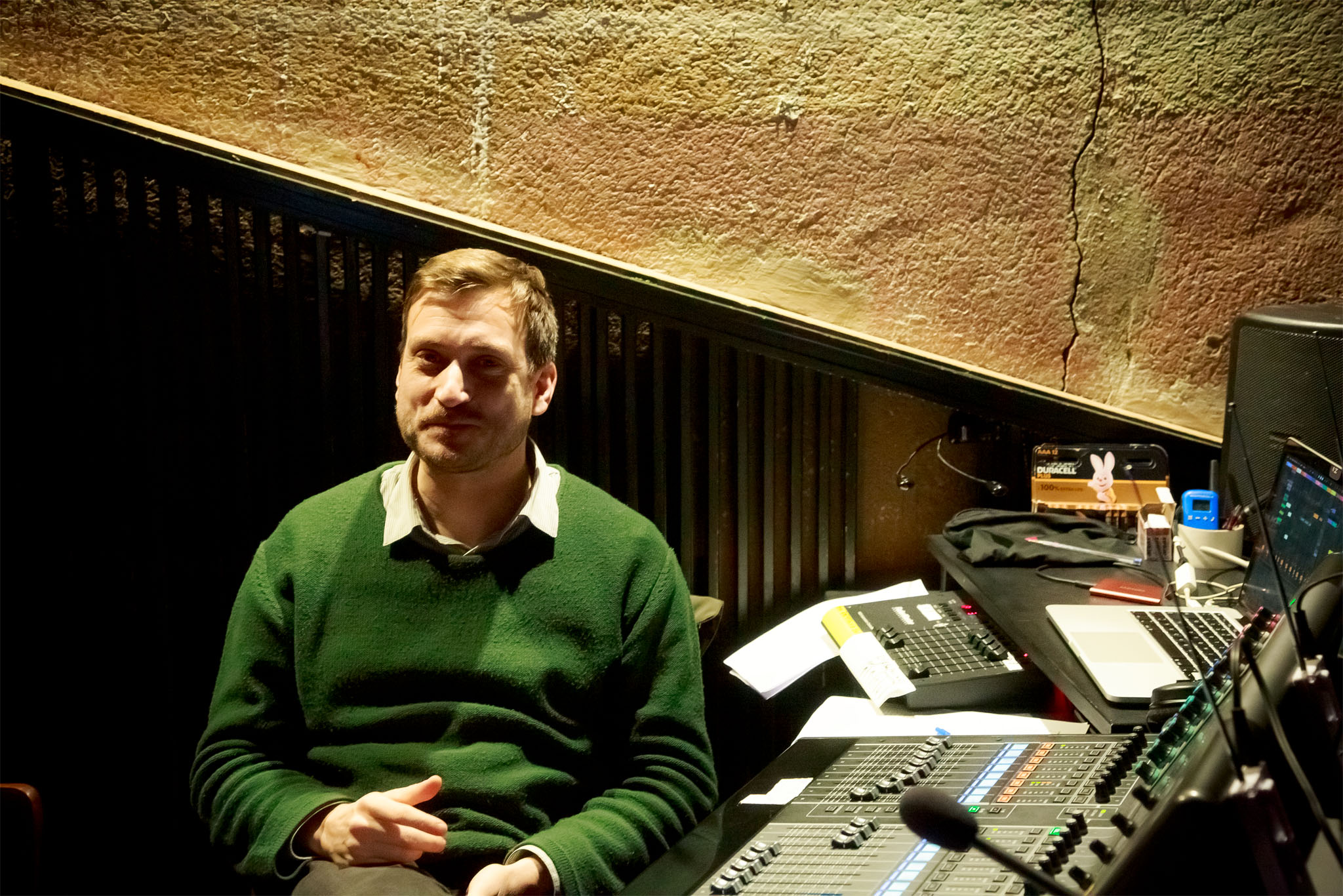 Sound designer Jan Brauer seated at his mixing desk in the operating position